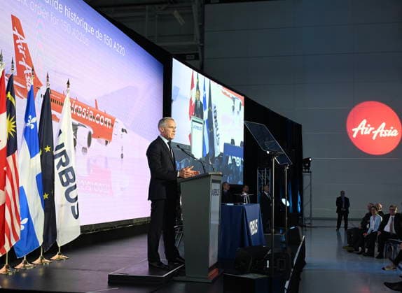 May 6, 2026, Mirabel, Pq, Canada: Prime Minister Mark Carney speaks during an event at the Airbus A220 Delivery Center in Mirabel, Que., Wednesday, May 6, 2026. AirAsia placed a landmark order for 150 Airbus A220 aircraft. Mirabel Canada  - ZUMAc35_ 20260506_zaf_c35_177 Copyright: xGrahamxHughesx