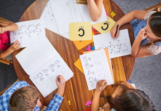 Time to learn something new. High angle shot of a group of unrecognisable young children working in class at school (License=RF) ,model released, Symbolfoto  Copyright: xZoonar.com ARNELLDMarshallx 20051680 ,model released, Symbolfoto ,property released