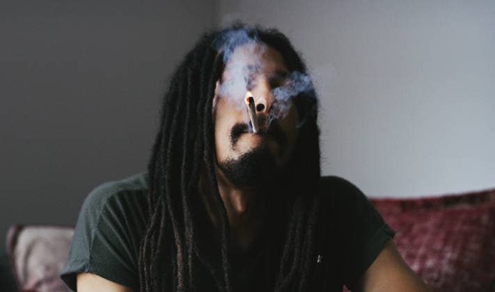 This is what I do to relax. a young man smoking a marijuana joint at home (License=RF) ,model released, Symbolfoto  Copyright: xZoonar.com KasperxRavlox 20097144 ,model released, Symbolfoto ,property released