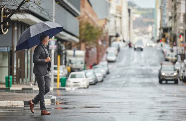 Walking, city and businessman with umbrella for rain in morning commute, travel and journey to office in winter. Professional, corporate and person in urban town for career, job and work in New York. (License=RF) ,model released, Symbolfoto  Copyright: xZoonar.com YurixArcursxpeopleimages.comx 21829019 ,model released, Symbolfoto ,property released