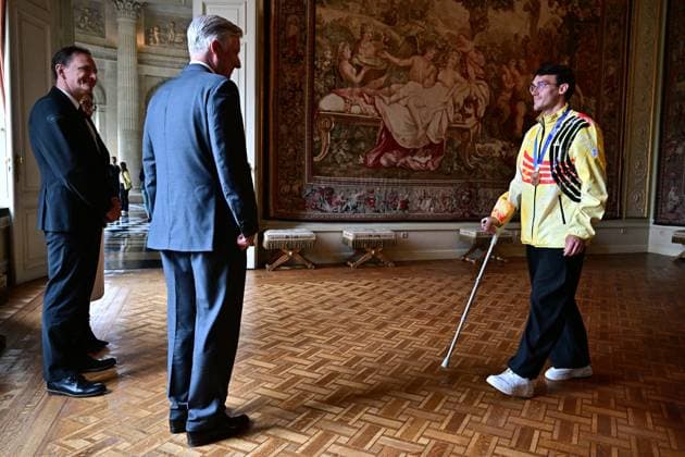 King Philippe - Filip of Belgium and Belgian shorttrack skater Stijn Desmet pictured during a royal reception for the athletes who competed at the Milano Cortina 2026 Olympic Winter Games, at the Royal Castle in Laken - Laeken, Brussels on Tuesday 12 May 2026. The XXV Winter Olympics took place from 6 to 22 February 2026 in Italy.  DIRKxWAEM 173596203
