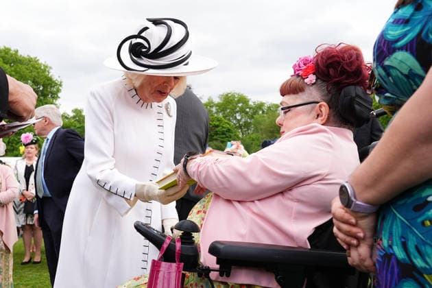 Royal Garden Party at Buckingham Palace Queen Camilla is presented with a book by Penny Pepper (right) as she greets guests during a Royal Garden Party at Buckingham Palace, London, to celebrate frontline workers from across the United Kingdom and recognise the dedication and contribution of those who serve their communities through volunteering, supporting charitable causes and working for emergency services. Picture date: Tuesday May 12, 2026., Credit:Aaron Chown PA ROTA - B68 Avalon UK, London  Copyright: xAaronxChownx xPAxROTAx-xB68x xAvalonx 1098334737