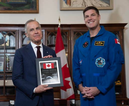 May 13, 2026, Ottawa, On, Canada: Prime Minister Mark Carney reacts as he is presented with a plaque and Canadian flag by Artemis II mission astronaut Jeremy Hansen during an event in Ottawa, Wednesday, May 13, 2026. Ottawa Canada  - ZUMAc35_ 20260513_zaf_c35_008 Copyright: xAdrianxWyldx