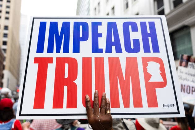 May 13, 2026, Houston, Texas, USA: During a No Kings protest in downtown Houston, a demonstrator holds up a sign reading Impeach Trump. Houston USA  - ZUMA 20260513_mda_g287_002 Copyright: xMatthewxGuzmanx