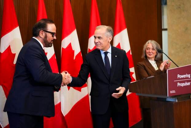 May 14, 2026, Ottawa, On, Canada: Prime Minister Mark Carney shakes hands with Russ Shewchuk International Vice -President for International Brotherhood of Electrical Workers (IBEW) First District, left, as they make an announcement alongside Minister of Environment and Climate Change Julie Dabrusin, right, on Parliament Hill in Ottawa on Thursday, May 14, 2026. Ottawa Canada - ZUMAc35_ 20260514_zaf_c35_017 Copyright: xSeanxKilpatrickx