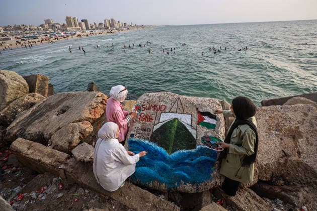Palestinian artists support the Global Sumud Flotilla in Gaza GAZA CITY, GAZA, PALESTINE - MAY 18: Palestinian women artists paint on a rock at the port in support of the Global Sumud Flotilla, which has been targeted by Israeli attacks in Gaza City, Gaza, Palestine, on May 18, 2026. The artwork depicts a ship moving through waves and carrying the colors of the Palestinian flag, conveying a message of support for the flotilla that set out to break the blockade and for global solidarity movements calling for its end. Hamza Z. H. Qraiqea Anadolu Gaza City Gaza. Editorial use only. Please get in touch for any other usage.  Copyright: x2026xAnadoluxHamzaxZ.xH.xQraiqeax