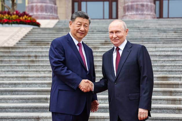 CHINA, BEIJING - MAY 20, 2026: Xi Jinping (L), President of China, and his counterpart Vladimir Putin of Russia shake hands during a welcoming ceremony in Tiananmen Square. Putin s official visit marks 25 years since the 2001 Treaty of Good Neighbourliness and Friendly Cooperation between Russia and China. Alexander Kazakov Russian Presidential Press and Information Office TASS  92770304