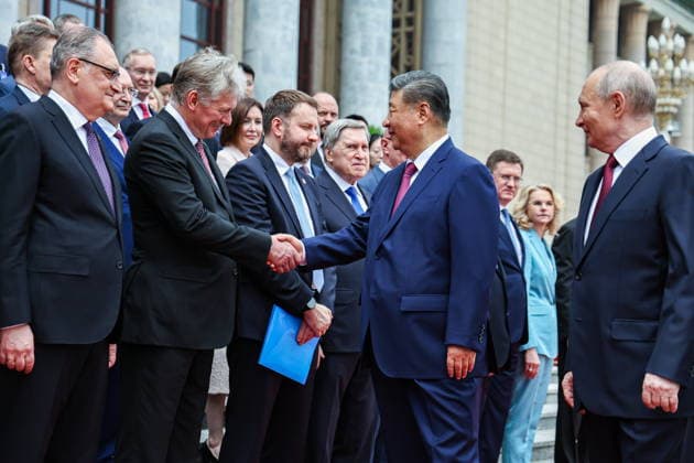 CHINA, BEIJING - MAY 20, 2026: Vladimir Putin, President of Russia, his counterpart Xi Jinping (R-L front) of China, Russia s Ambassador Igor Morgulov, Presidential Press Secretary Dmitry Peskov, Maxim Oreshkin, Deputy Chief of Staff, Presidentia Executive Office, and Presidential Aide Yuri Ushakov (L-R front) shake hands during a welcoming ceremony in Tiananmen Square. Putin s official visit marks 25 years since the 2001 Treaty of Good Neighbourliness and Friendly Cooperation between Russia and China. Alexander Kazakov Russian Presidential Press and Information Office TASS  92771191