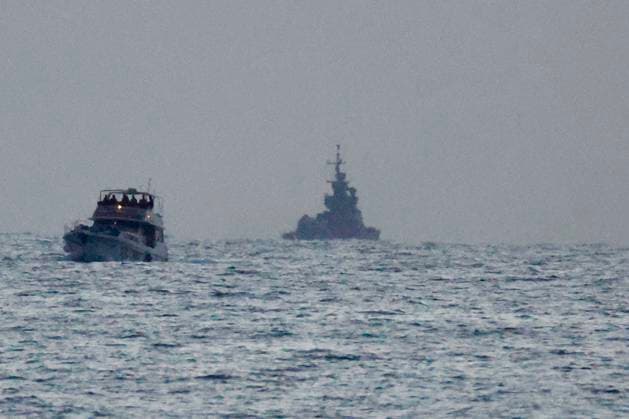 (260520) -- ASHDOD, May 20, 2026 -- A boat of the Gaza-bound aid flotilla (L), after being intercepted by the Israeli navy, is escorted toward the Israeli port of Ashdod, Israel, on May 19, 2026. Israel said late Tuesday that it had intercepted all boats in a Gaza-bound aid flotilla, detaining hundreds of activists and transporting them to Israel. (Photo by Xinhua) ISRAEL-ASHDOD-GAZA-BOUND AID FLOTILLA JamalxAwad 