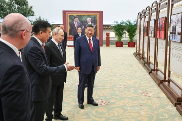 CHINA, BEIJING - MAY 20, 2026: Xi Jinping, President of China, his counterpart Vladimir Putin of Russia, accompanied by Fu Hua, President of the Xinhua News Agency, and Andrei Kondrashov (R-L front), TASS Director General, view a photography exhibition titled Unwavering Friendship of the Great Nations, Strategic Partnership of the Great Powers and held jointly by TASS and Xinhua to mark 25 years since the 2001 Treaty of Good Neighbourliness and Friendly Cooperation between Russia and China. Alexander Kazakov Russian Presidential Press and Information Office TASS  92783763