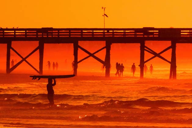 May 20, 2026, Isle Of Palms, Sc, United States: A surfer silhouetted by the sunrise carries his board out into deeper water on Front Beach, May 20, 2026 in Isle of Palms, South Carolina. Isle Of Palms United States  - ZUMAe02_ 20260520_zaf_e02_005 Copyright: xRichardxEllisx