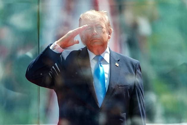 President Donald Trump salutes during the National Anthem before delivering the commencement address at the United States Coast Guard Academy s graduation ceremony in New London, Connecticut on Wednesday, May 20, 2026.  CONN20260520435 ANGELINAxKATSANIS