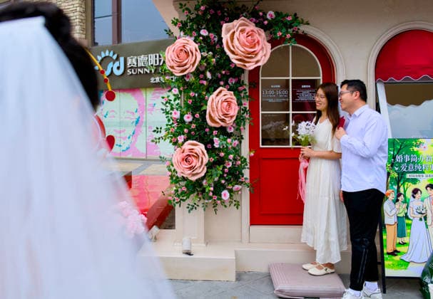 BEIJING, CHINA - MAY 20: A newly-wed couple pose for a photo at the marriage registration office during 520 I Love You Day on May 20, 2026 in Beijing, China. Chinese people celebrate 520 I Love You Day as 520 sounds like I love you in Chinese.  Copyright: xVCGx 111642848286