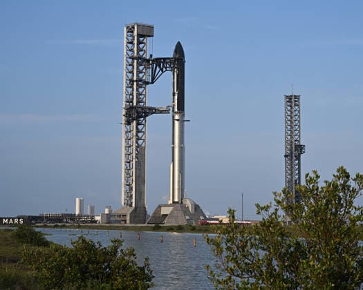 The SpaceX Super Heavy Booster and Starship spacecraft stand on Orbital Launch Pad 2 at Starbase, Texas during the early evening on Wednesday May 20, 2026. SpaceX remains on schedule so far for a launch attempt on Thursday, May 21. SpaceX is monitoring all the upgrades made on the new pad, the booster and Starship. The launch window will open at 5:30 PM.  SBP20260520001 JOExMARINO