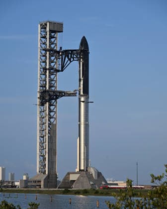 The SpaceX Super Heavy Booster and Starship spacecraft stand on Orbital Launch Pad 2 at Starbase, Texas during the early evening on Wednesday May 20, 2026. SpaceX remains on schedule so far for a launch attempt on Thursday, May 21. SpaceX is monitoring all the upgrades made on the new pad, the booster and Starship. The launch window will open at 5:30 PM.  SBP20260520002 JOExMARINO