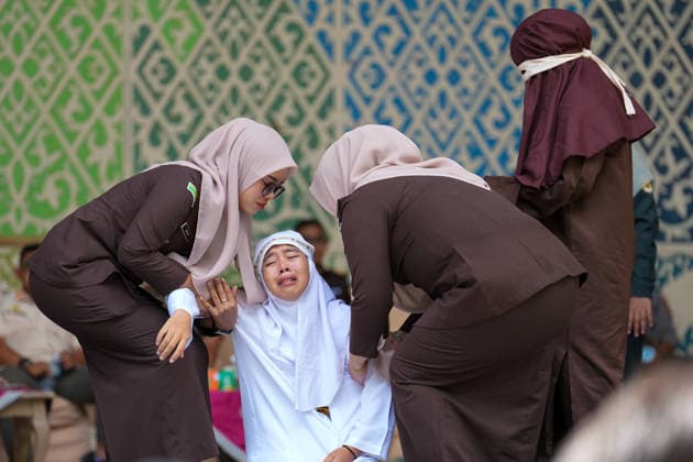 May 21, 2026, Kuta Alam, Banda Aceh, Indonesia: Officers assist a Sharia violator for adultery who is in pain after receiving 100 lashes in Banda Aceh, Aceh Province, Indonesia, on Thursday. The caning was imposed after being found guilty of violating Sharia law in Aceh. The public caning serves as a form of education and transparency in the implementation of punishment, guaranteed by the Aceh Qanun (Aceh Law), which was passed in 2014. Kuta Alam Indonesia - ZUMAi115 20260521_zip_i115_038 Copyright: xMuhammadxIqbalx