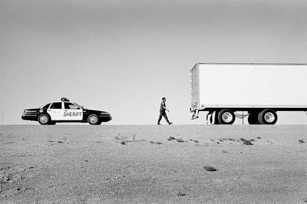 Cops: Riding Shotgun With Texas Sheriffs 1997, El Paso, Texas, USA: Texas sheriff approaching a eighteen wheeler one highway on foot after p ulling trucker over in his highway patrol police car. Large 18 wheeler trucks are commonly used for passing tons of drugs into the country. Copyright: xJeromexBrunetx