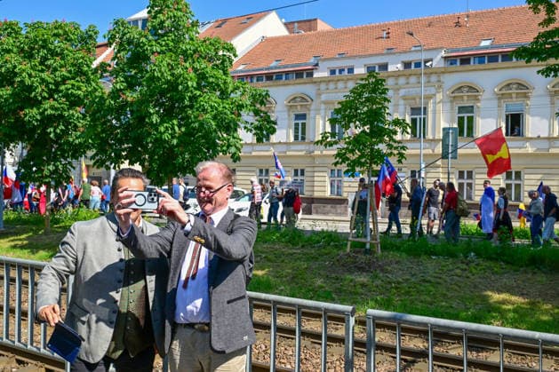 A manifestation happening Nema barikada (Dumb Barricade) to express opposition to the Sudeten German Congress in Brno, Czech Republic, on May 22, 2026. In the picture, one of the participants of the congress takes a selfie with the protesting opponents of the congress. (CTKxPhoto VaclavxSalek) CTKPhotoP2026052203451  CTKPhotoP2026052203451