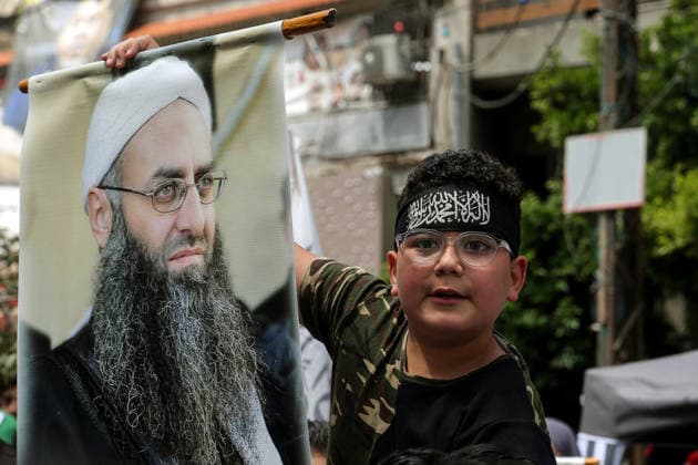 May 22, 2026, Beirut, Beirut, Lebanon: A Sunni Muslim boy, displays the picture of Salafist cleric Sheikh Ahmad al-Assir during a protest in Beirut demanding the release of al-Assir and other imprisoned Islamic detainees in a proposed General Amnesty Law. The law was stalled after supporters and families of Islamists have taken the streets to demand releases and sentence reductions, a key point of contention is whether the pardon will cover al-Assir, who was sentenced to death by a military court for 2013 and 2014 clashes with the Lebanese Armed Forces. Beirut Lebanon - ZUMAn313 20260522_zip_n313_004 Copyright: xMarwanxNaamanix