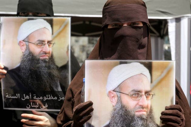May 22, 2026, Beirut, Beirut, Lebanon: Fully veiled Sunni Muslim women display pictures of Salafist cleric Sheikh Ahmad al-Assir during a protest demanding the release of the cleric as well as other imprisoned Islamic detainees in a proposed General Amnesty Law. The law was stalled after supporters and families of Islamists have taken the streets to demand releases and sentence reductions, a key point of contention is whether the pardon will cover al-Assir, who was sentenced to death by a military court for 2013 and 2014 clashes with the Lebanese Armed Forces. Beirut Lebanon  - ZUMAn313 20260522_zip_n313_007 Copyright: xMarwanxNaamanix