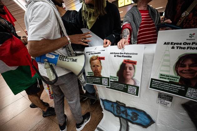 Pro-Palestinian activists pictured before Belgian activists who were part of the Gaza Flotilla arrive at Brussels Airport, in Zaventem, Friday 22 May 2026.  EMILExWINDAL 174749031