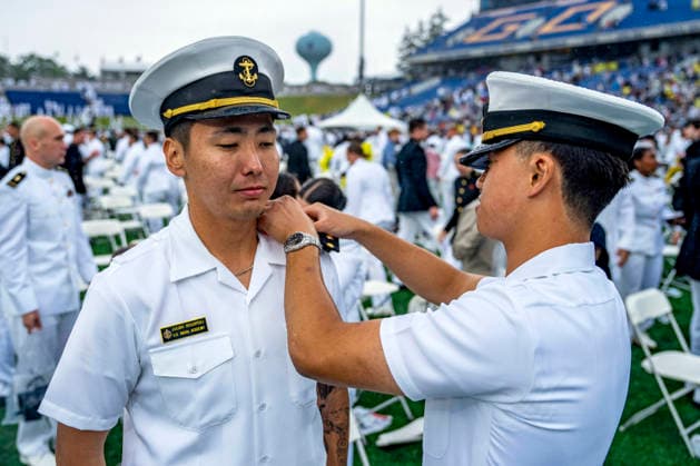 A Naval Academy graduate has his hard shoulder boards changed after the U.S. Naval Academy Graduation and Commissioning Ceremony at the U.S. Naval Academy in Annapolis, Maryland on Friday, May 22, 2026. The Naval Academy has a total of 1059 graduates.  ANN20260522349 BONNIExCASH