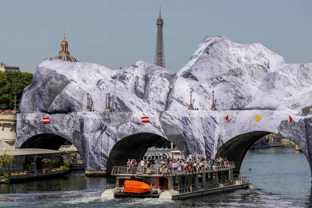 Paris, France May 23, 2026 - The Seine flows beneath JR s artwork titled La Caverne du Pont-Neuf on May 23, 2026 in Paris, France. In homage to the work by Christo and Jeanne-Claude, who wrapped the Pont-Neuf in 1985, the artist JR is currently installing the world™s largest immersive artwork, La Caverne du Pont-Neuf, which measures 120 meters long, 20 meters wide, and between 12 and 18 meters high. ARTISTE JR, ART, INSTALLATION ARTISTIQUE, ILLUSTRATION, PAYSAGE URBAIN, PONT NEUF, MONUMENT, VUE DE PARIS, OEUVRE D ART MONUMENTALE EPHEMERE, INSOLITE, ARCHITECTURE, TOUR EIFFEL  Copyright: xVincentxIsorex