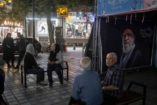 Daily Life In Iran Amid Threat About New Possible War Two elderly Iranian men sit together beneath a banner depicting a portrait of Iran s late Supreme Leader Ayatollah Ali Khamenei in a business district in downtown Tehran, Iran, on May 22, 2026. U.S. President Donald Trump has indicated the possibility of military action against Iran if no agreement is reached with Iranian officials, according to official reports. Tehran Tehran Iran  Copyright: xMortezaxNikoubazlx originalFilename: nikoubazl-dailylif260522_npEDv.jpg