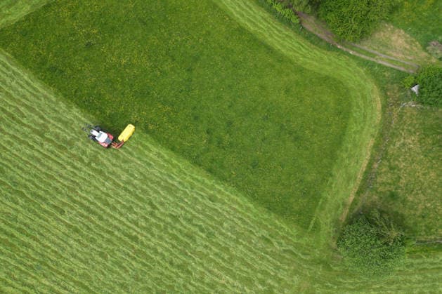 Luftaufnahme. Fruehling (Frühling) im Siegerland. Eine saftig gruene (grüne) Wiese wird von einem Traktor mit einem Maehwerk (Mähwerk) bei Siegen-Oberschelden gemaeht (gemäht). Fruehling (Frühling) im Siegerland am 23.05.2026 in Siegen Deutschland. *** Aerial view spring spring in Siegerland A lush green meadow is mowed by a tractor with a mower mower near Siegen Oberschelden spring spring in Siegerland on 23 05 2026 in Siegen Germany