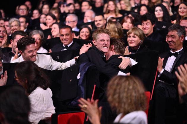 Cannes - Closing Ceremony (L) Lukas Dhont celebrates with Belgian actor Emmanuel Macchia and French actor Valentin Campagne after they together won ex-aequo the Best Actor Prize for the film Coward on stage during the closing ceremony of the 79th edition of the Cannes Film Festival in Cannes, France on May 23, 2026. Photo by Eliot Blondet ABACAPRESS.COM Cannes France  Copyright: xBlondetxEliot ABACAx
