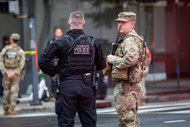 May 23, 2026, Washington, Dc, USA: A Secret Service officer and a National Guardsman stand together near the scene where a gunman fired a volley of shots by the White House before being shot and fatally wounded by U.S. Secret Service police officers. Aanother person was injured, according to law enforcement officials. Washington, DC, May 23, 2026. Photo: Zuma Press Washington USA - ZUMAmj3_ 20260523_zaf_mj3_002 Copyright: xJayxMallinx