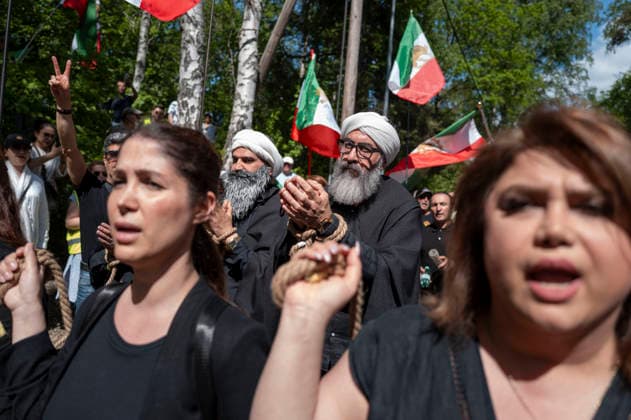 May 24, 2026, Stockholm, Sweden: Anti-Iranian regime protesters gather outside the Iranian Embassy in Stockholm, Sweden, on May 24, 2026, calling on Sweden to close the embassy and demanding restored internet access in Iran. Some demonstrators carried flags and signs in support of Reza Pahlavi. During the protest, participants staged a symbolic performance depicting imprisoned women confronting captured clerics, while chanting slogans against the Iranian regime and the ruling mullahs. Sweden - ZUMAa136 20260524_zap_a136_005 Copyright: xJoelxLindhex
