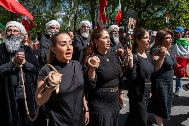 May 24, 2026, Stockholm, Sweden: Anti-Iranian regime protesters gather outside the Iranian Embassy in Stockholm, Sweden, on May 24, 2026, calling on Sweden to close the embassy and demanding restored internet access in Iran. Some demonstrators carried flags and signs in support of Reza Pahlavi. During the protest, participants staged a symbolic performance depicting imprisoned women confronting captured clerics, while chanting slogans against the Iranian regime and the ruling mullahs. Sweden  - ZUMAa136 20260524_zap_a136_026 Copyright: xJoelxLindhex