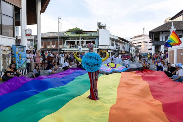 May 24, 2026, Chiang Mai, Thailand: Sirisak Chaited, representative of the Chiang Mai Pride organizing committee, poses on a large rainbow flag during the Chiang Mai Pride Parade. The Chiang Mai Pride Parade 2026 took place in Chiang Mai, Thailand. Chiang Mai province holds Thailandis first Pride Month celebrations annually, promoting gender equality, diversity, and human rights as part of Pride Month activities in northern Thailand. Chiang Mai Thailand  - ZUMAs197 20260524_aaa_s197_149 Copyright: xPongmanatxTasirix