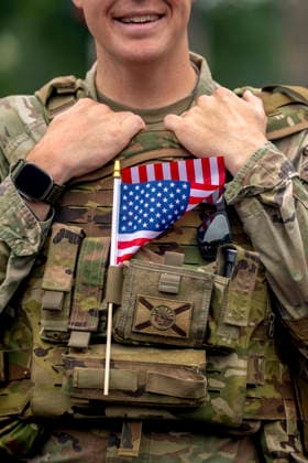 A member of the U.S. National Guard holds a flag in his vest while patrolling the Memorial Day Parade on Memorial Day in Washington, DC on Monday, May 25, 2026.  WAP20260525315 BONNIExCASH