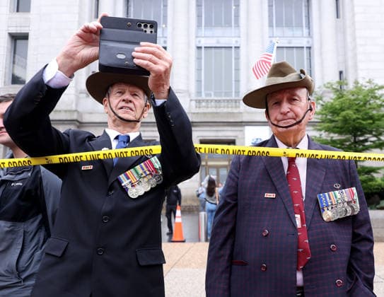 May 25, 2026, Washington, District Of Columbia, USA: Veterans with American flags watch the National Memorial Day Parade in Washington, DC, USA, on May 25, 2026. The parade has been held annually since 2005, marking its 21st anniversary. Washington USA  - ZUMAs337 20260525_znp_s337_029 Copyright: xGentxShkullakux