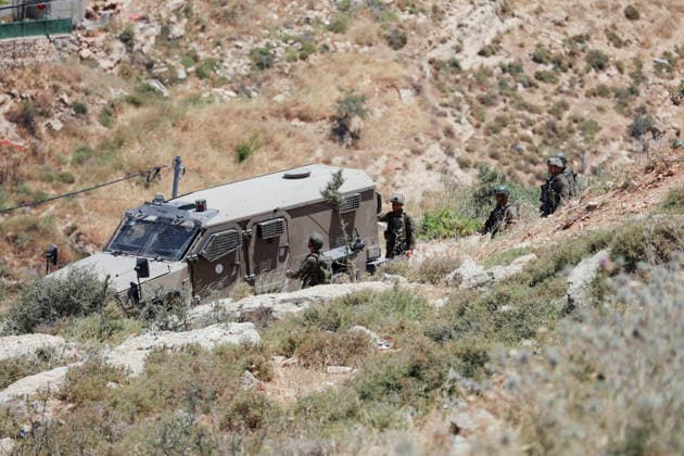 Israeli Demolition West Bank Family Displaced Eid Al-Adha Israeli soldiers gather near an Israeli military vehicle parked on a rocky hillside in Nahhalin, occupied West Bank, on May 25, 2026, after a demolition operation. The demolition, carried out by Israeli forces who stated the structure was built without a permit, displaced an eight-member Palestinian family just two days before the Islamic holiday of Eid al-Adha. Bethlehem West Bank Palestinian Territories Copyright: xMosabxShawerx