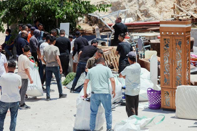 Israeli Demolition West Bank Family Displaced Eid Al-Adha People stand near salvaged furniture and household items gathered outside a destroyed home in Nahhalin, occupied West Bank, on May 25, 2026. The demolition, carried out by Israeli forces who stated the structure was built without a permit, displaced an eight-member Palestinian family just two days before the Islamic holiday of Eid al-Adha. Bethlehem West Bank Palestinian Territories Copyright: xMosabxShawerx