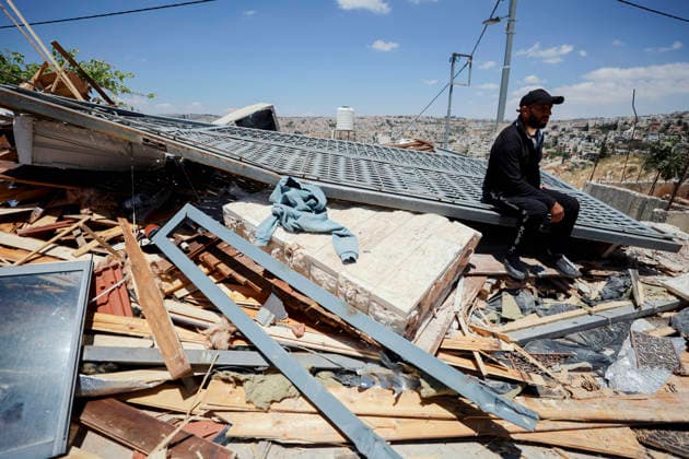 Israeli Demolition West Bank Family Displaced Eid Al-Adha A man sits on a metal gate resting on top of rubble following a home demolition in Nahhalin, occupied West Bank, on May 25, 2026. The demolition, carried out by Israeli forces who stated the structure was built without a permit, displaced an eight-member Palestinian family just two days before the Islamic holiday of Eid al-Adha. Bethlehem West Bank Palestinian Territories Copyright: xMosabxShawerx