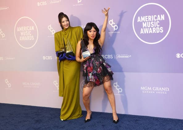 EJAE and Rei Ami of Huntrix, winners of the Song of the Year, Best Pop Song and Best Vocal Performance awards for Golden, appear backstage on the winners walk during the 52nd annual American Music Awards at the MGM Grand Garden Arena in Las Vegas on Monday, May 25, 2026.  LAV20260525575 JAMESxATOA