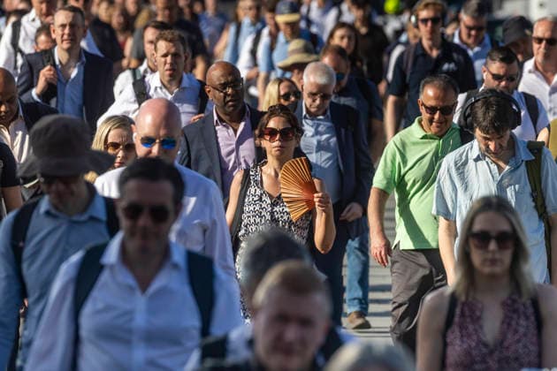 May 26, 2026, London, London, UK: London, UK. A commuter crossing London Bridge cools down with a folding fan. According to the weather office, it will be another fine and dry day. High of 35Ã‚Â°C. London UK  - ZUMAl94_ 20260526_zaf_l94_008 Copyright: xMarcinxNowakx
