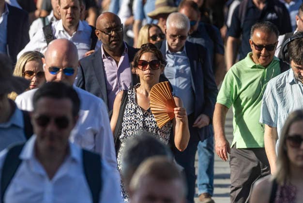 May 26, 2026, London, London, UK: London, UK. A commuter crossing London Bridge cools down with a folding fan. According to the weather office, it will be another fine and dry day. High of 35Ã‚Â°C. London UK  - ZUMAl94_ 20260526_zaf_l94_012 Copyright: xMarcinxNowakx