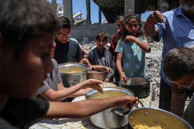 Palestinians line up to receive food inside the Jabalia refugee camp in the northern Gaza Strip. Jabalia - May 23, 2026: Palestinians line up to get food inside the Jabalia refugee camp in the northern Gaza Strip, near the Yellow Line. This line consists of concrete blocks placed by the Israeli army along the length of the Strip from north to south. The Israeli army controls more than 60% of the Strip s area. (Photo by Rizek ELdremle ) Jabalia Copyright: xx