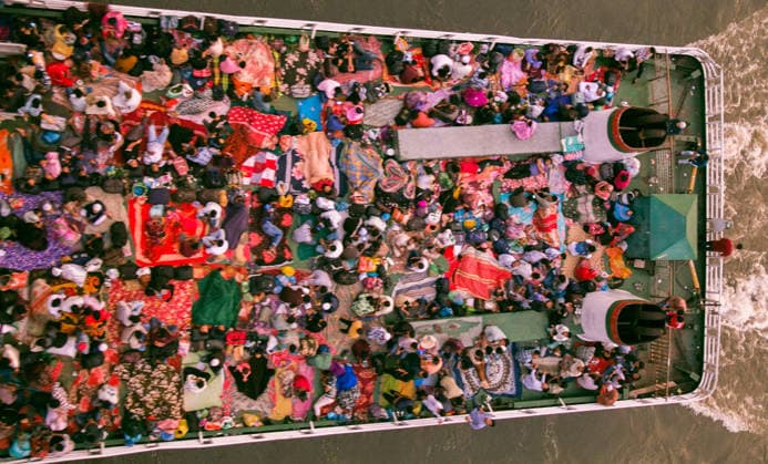 May 26, 2026, Dhaka, Munshiganj, Bangladesh: MUNSHIGANJ, BANGLADESH Ã¢â‚¬ MAY 2026: An aerial top-down view captured from the Mukterpur Bridge in Munshiganj shows overcrowded passenger ferries (locally known as launches) traveling along the river, packed with thousands of home-bound people leaving Dhaka s Sadarghat terminal. Every year, ahead of the Muslim festival of Eid-ul-Adha, millions of people working in the capital city Dhaka endure hectic journeys and brave overcrowded public transport to return to their ancestral villages and celebrate the festival with their families. Many passengers who fail to secure indoor cabins opt to spend the hours-long journey on the open top decks, layout out colorful blankets, mats, and sheets to rest  - ZUMAa259 20260526_zip_a259_005 Copyright: xRayhanxAhmedx