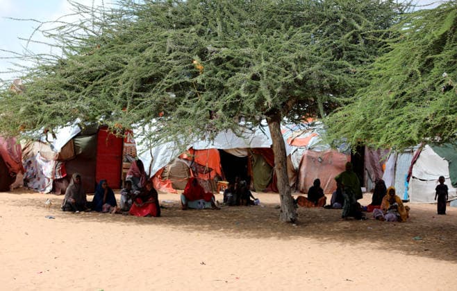 Camps turn into permanent settlements amid ongoing crisis in Somalia MOGADISHU, SOMALIA - MAY 26: People spend time in the shadow of a tree as millions of people living in camps that have gradually turned into permanent settlements, where they continue to face difficult living conditions amid insecurity, conflict and drought in the capital Mogadishu, Somalia, on May 26, 2026. Metin Yuksel Kaya Anadolu Mogadishu Somalia. Editorial use only. Please get in touch for any other usage.  Copyright: x2026xAnadoluxMetinxYukselxKayax