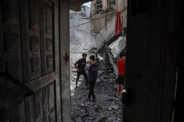 Nuseirat Homes Destroyed Airstrike Palestinian children walk through debris following an Israeli strike in Nuseirat in the central Gaza Strip on May 26, 2026. The strike came amid the ongoing war between Israel and Hamas, which has devastated large parts of the Gaza Strip and displaced much of its population. Nuseirat Gaza Strip Palestinian Territories Copyright: xAhmedxYounisx