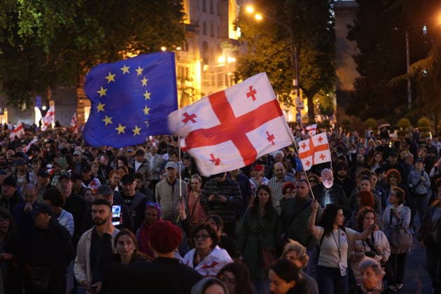 Anti-government protest in Tbilisi TBILISI, GEORGIA - MAY 26: Pro-EU demonstrators wave national flags of Georgia, the European Union, the United States, and Ukraine during an anti-government protest rally outside the Parliament Building on Rustaveli Avenue in Tbilisi, Georgia on May 26, 2026. Organized by the Opposition Alliance , a coalition of various pro-Western opposition political parties, the peaceful demonstration began in the evening hours outside the main entrance of Ivane Javakhishvili Tbilisi State University before marching through the central streets of the capital. Thousands of participants chanted anti-government slogans and accused the ruling party of executing ineffective foreign policies that threaten to derail Georgia s  Copyright: x2026xAnadoluxDavitxKachkachishvilix