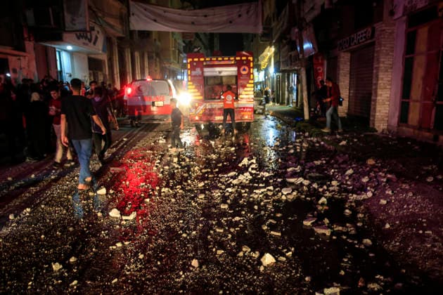 Gaza Rimal District Rocked Strikes Palestinians gather near a fire truck at the site of an airstrike in the Al-Rimal neighborhood of central Gaza City on May 26, 2026, after seven Israeli airstrikes hit a residential building and caused heavy damage to nearby vehicles and commercial shops. Several people were killed and others injured in the strikes, including passersby who had been shopping ahead of Eid. Gaza Gaza Strip Palestinian Territories Copyright: xSaeedxJarasx