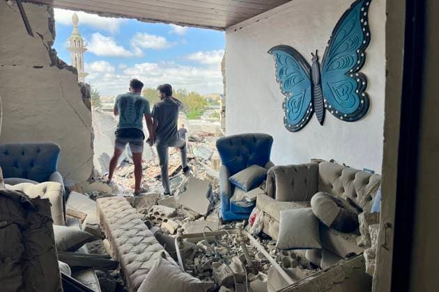 (260527) -- TYRE, May 27, 2026 -- People stand among the debris of a house destroyed by an Israeli airstrike in Tyre, Lebanon, May 26, 2026. Israeli strikes on southern and eastern Lebanon killed at least 18 people and wounded more than 20 others on Tuesday, according to Lebanon s official sources, as Israel intensified its bombardment campaign across southern Lebanon. (Photo by Xinhua) LEBANON-TYRE-ISRAELI RAID AlixHashisho 