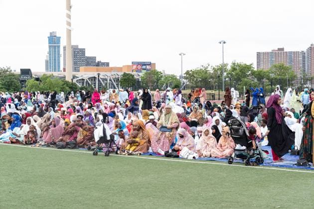 May 27, 2026, New York, New York, USA: Women with children gathered on the back separately from men as Mayor Zohran Mamdani delivers remarks during Eid Al-Adha holiday prayers at The Yancy Track & Field in New York, NY on May 27, 2026. Hundreds of men, women and children attended wearing clean, colorful and expensive traditional clothes. Eid al-Adha translates from Arabic to Festival of Sacrifice is one of the most important holidays in the Islamic calendar. It honors the Prophet Ibrahim s (Abraham s in Judaism) absolute obedience to God, commemorating his willingness to sacrifice his son as an act of submission before God provided a ram to sacrifice instead. New York USA - ZUMAr339 20260527_znp_r339_001 Copyright: xLevxRadinx